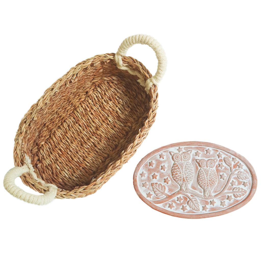 Woven bread warmer basket with decorative plate featuring owl design on a white background