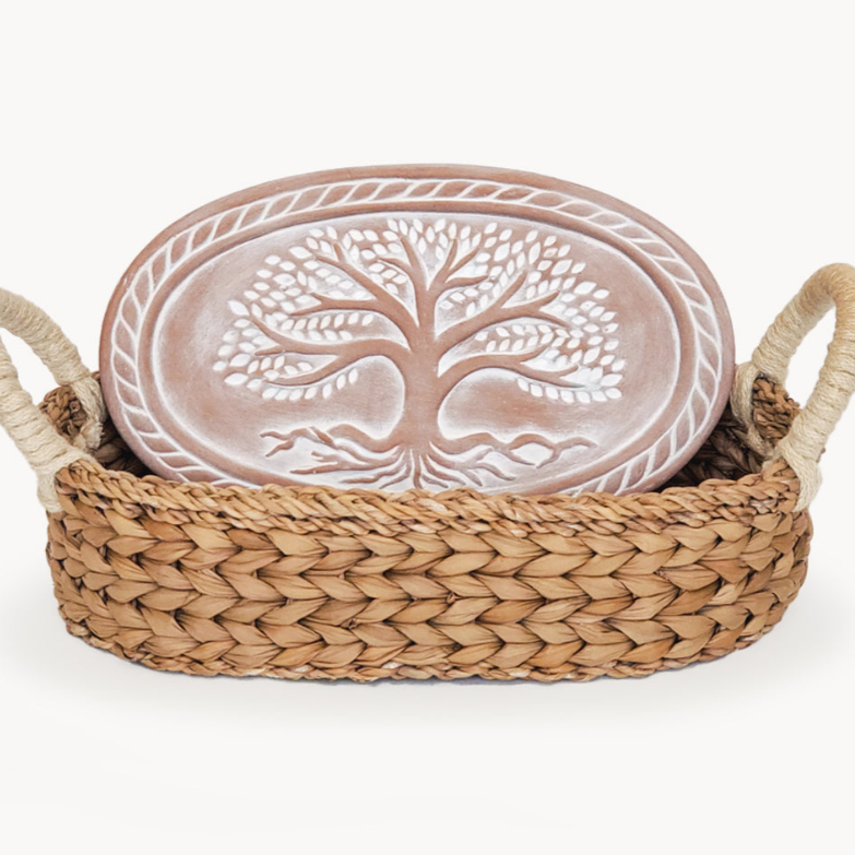 Ceramic plate with tree design in a woven basket on a white background